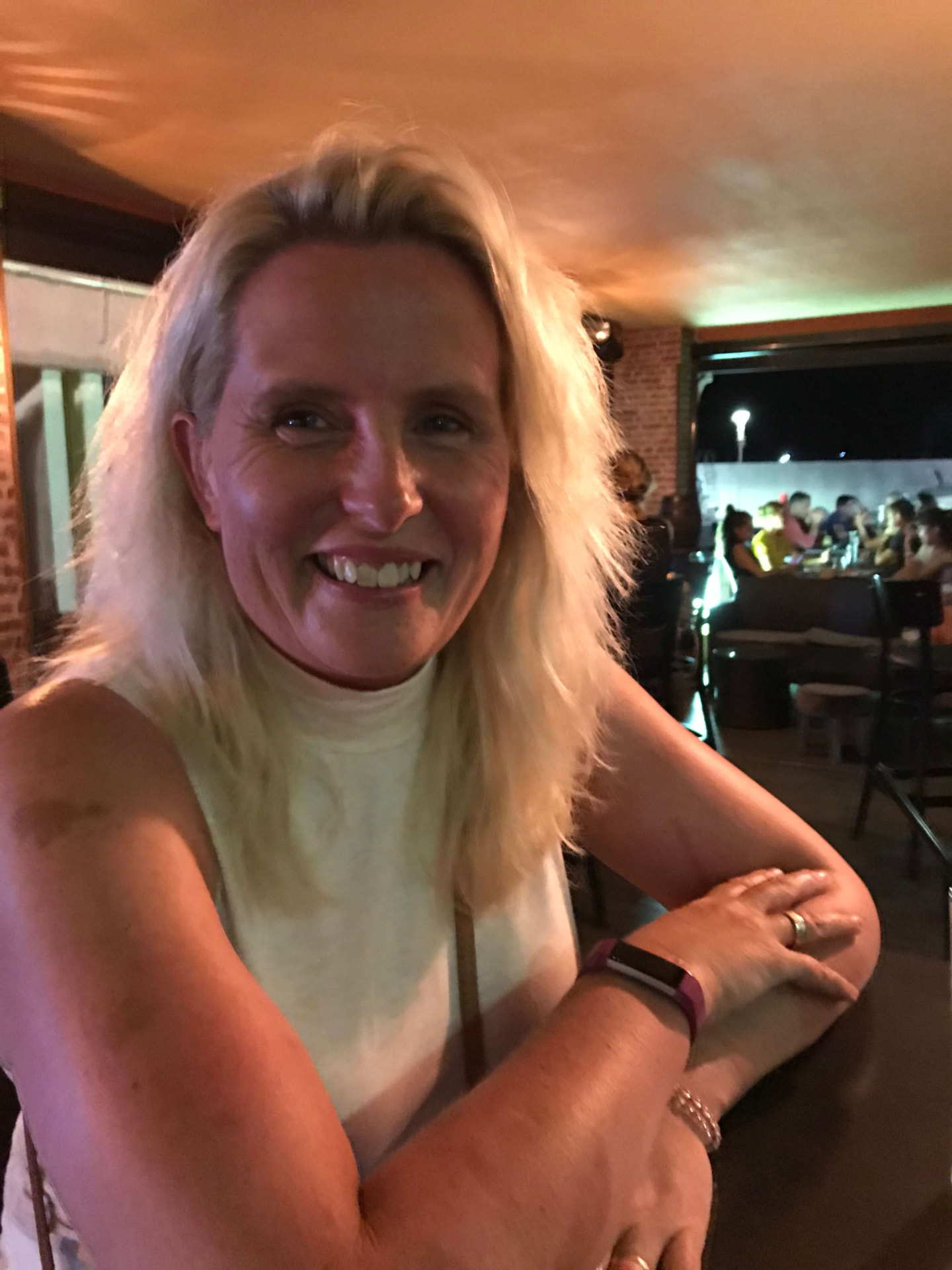 Heidi Sawyer smiling, seated at a restaurant table.